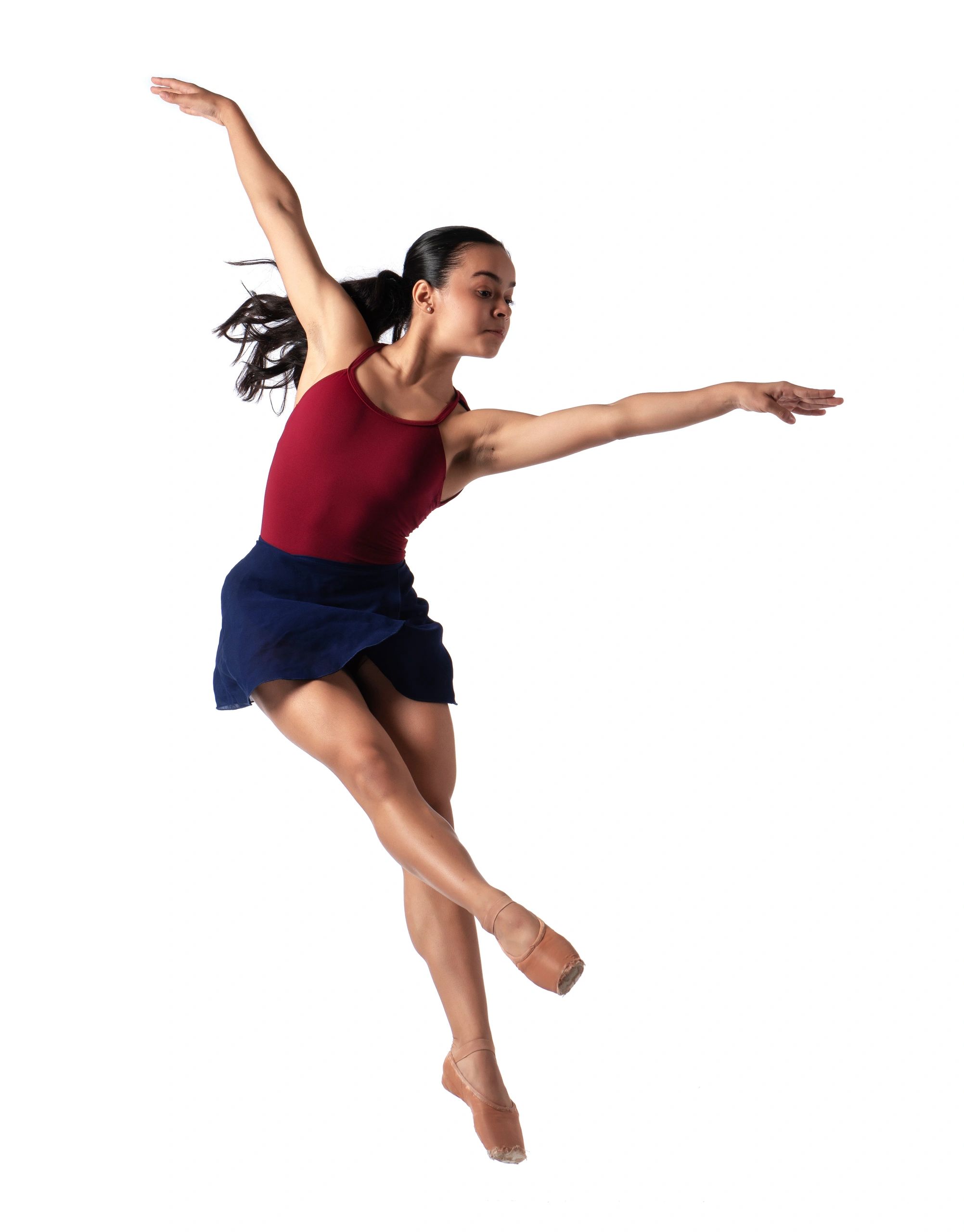 Young ballerina performing a graceful jump